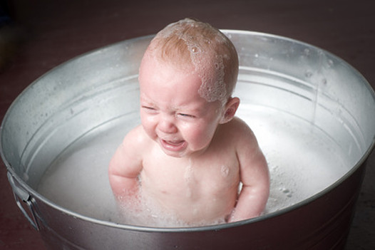 Crying baby in bathtub
