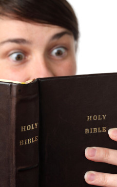 Surprised man reading Bible
